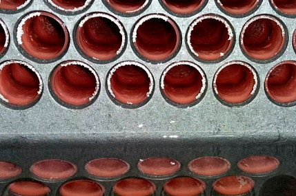 Cleaning systems for shell and tube heat exchangers